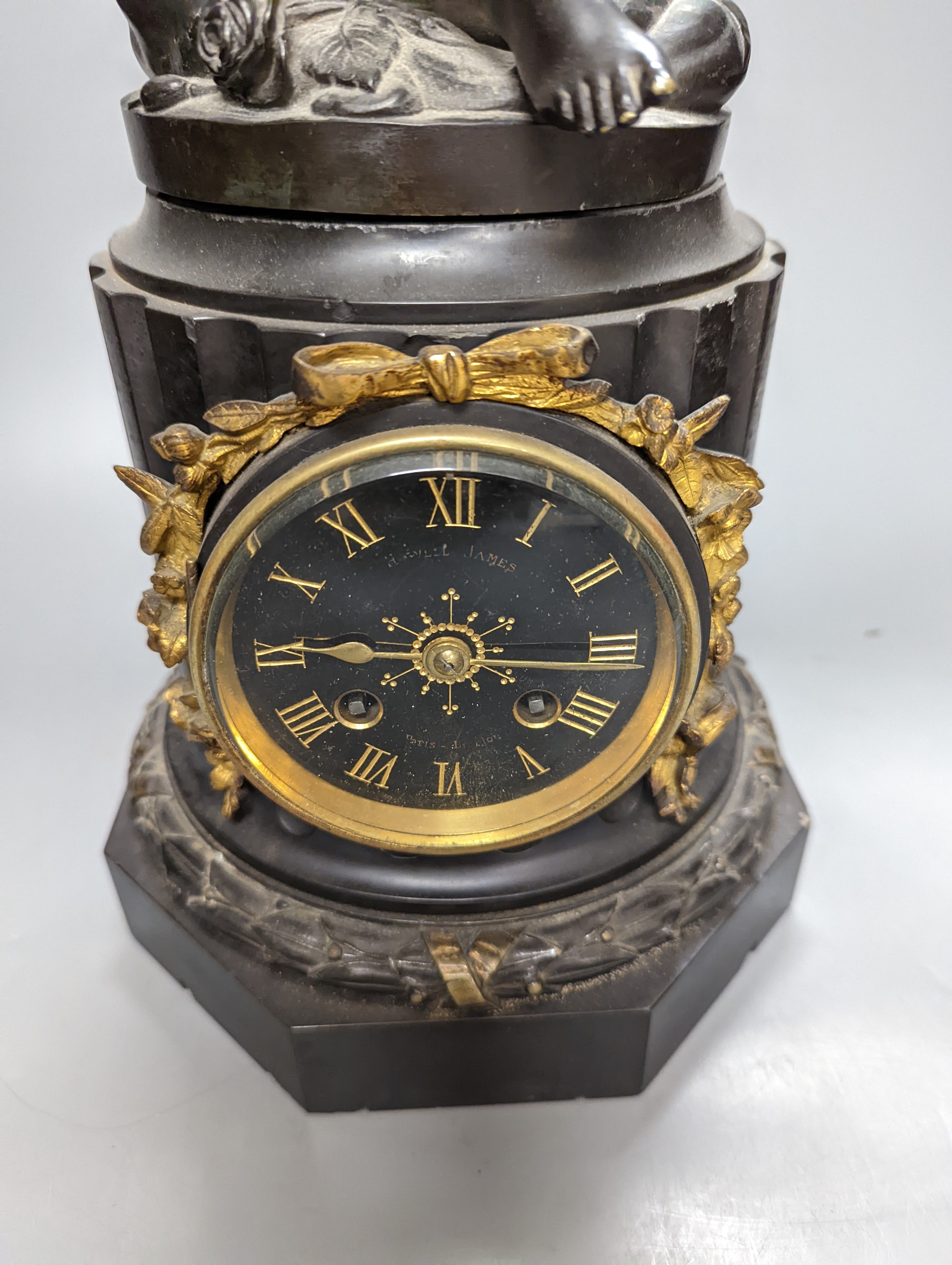 A Late 19th century French bronze and black slate mantel clock, with cherub surmount, drum movement, height 46cm